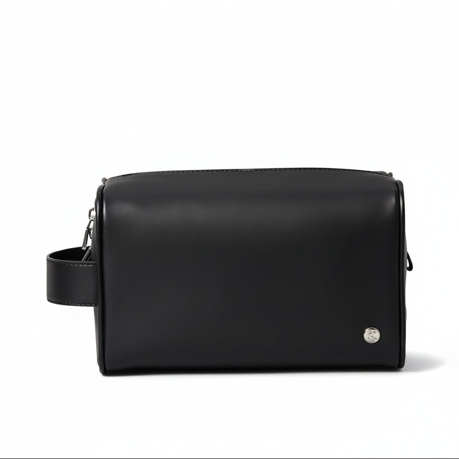 Black leather bag on a beige background