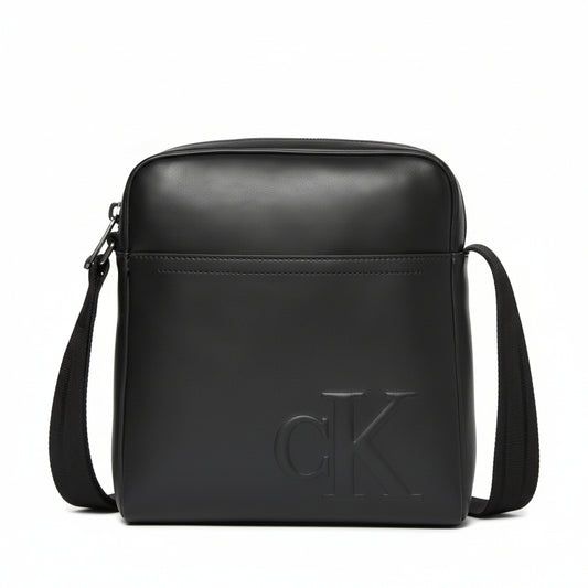 Calvin Klein Raised Reporter Bag in black faux leather