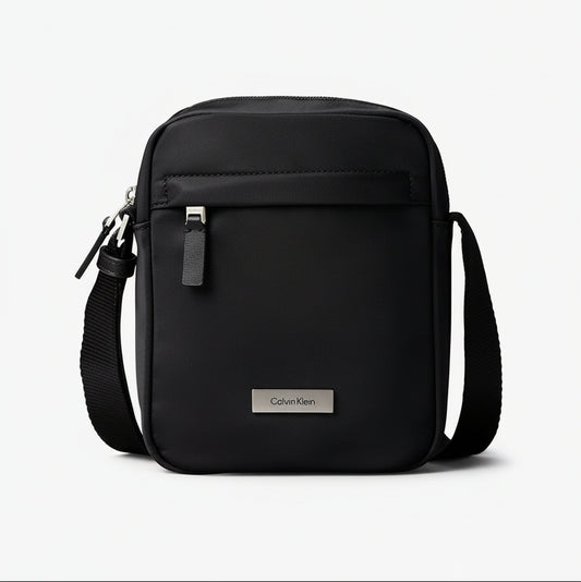 Calvin Klein reporter bag, a compact, modern shoulder or crossbody bag designed for carrying essentials