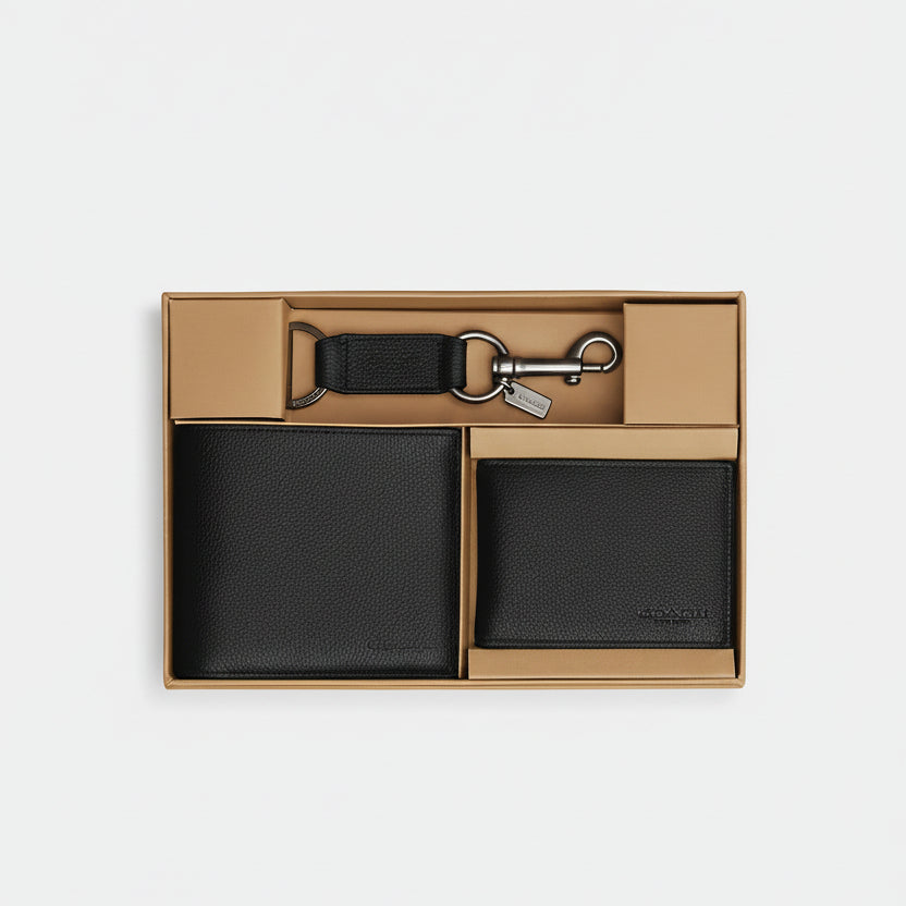 Black leather wallet and keychain set in a box on a white background
