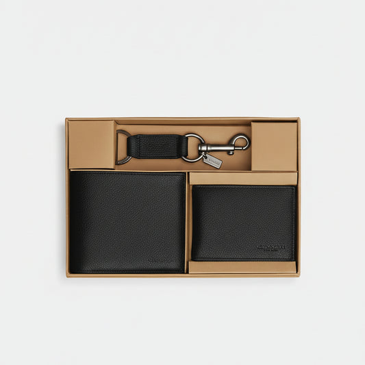 Black leather wallet and keychain set in a box on a white background