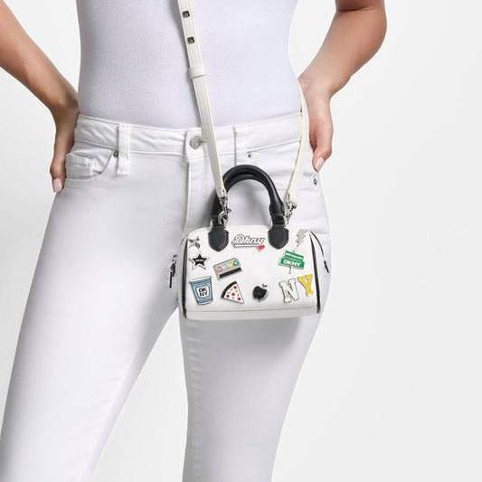 DKNY Nell Mini Satchel Crossbody in white polyurethane with New York themed patches