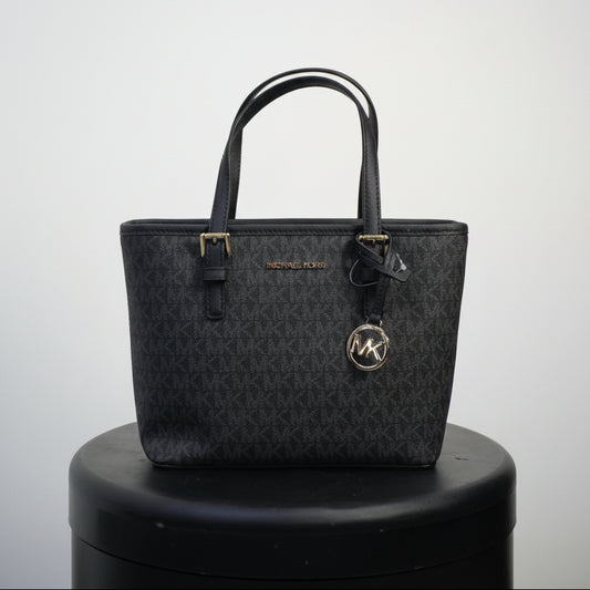 Michael Kors Jet Set Travel tote bag in black with a signature logo print