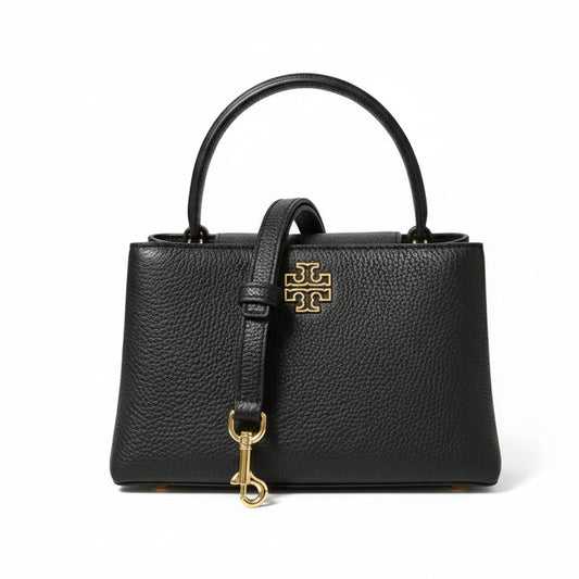 Black handbag with gold clasp and logo on a white background