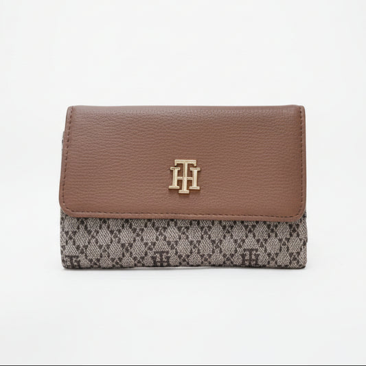 Brown wallet with a patterned flap on a white background